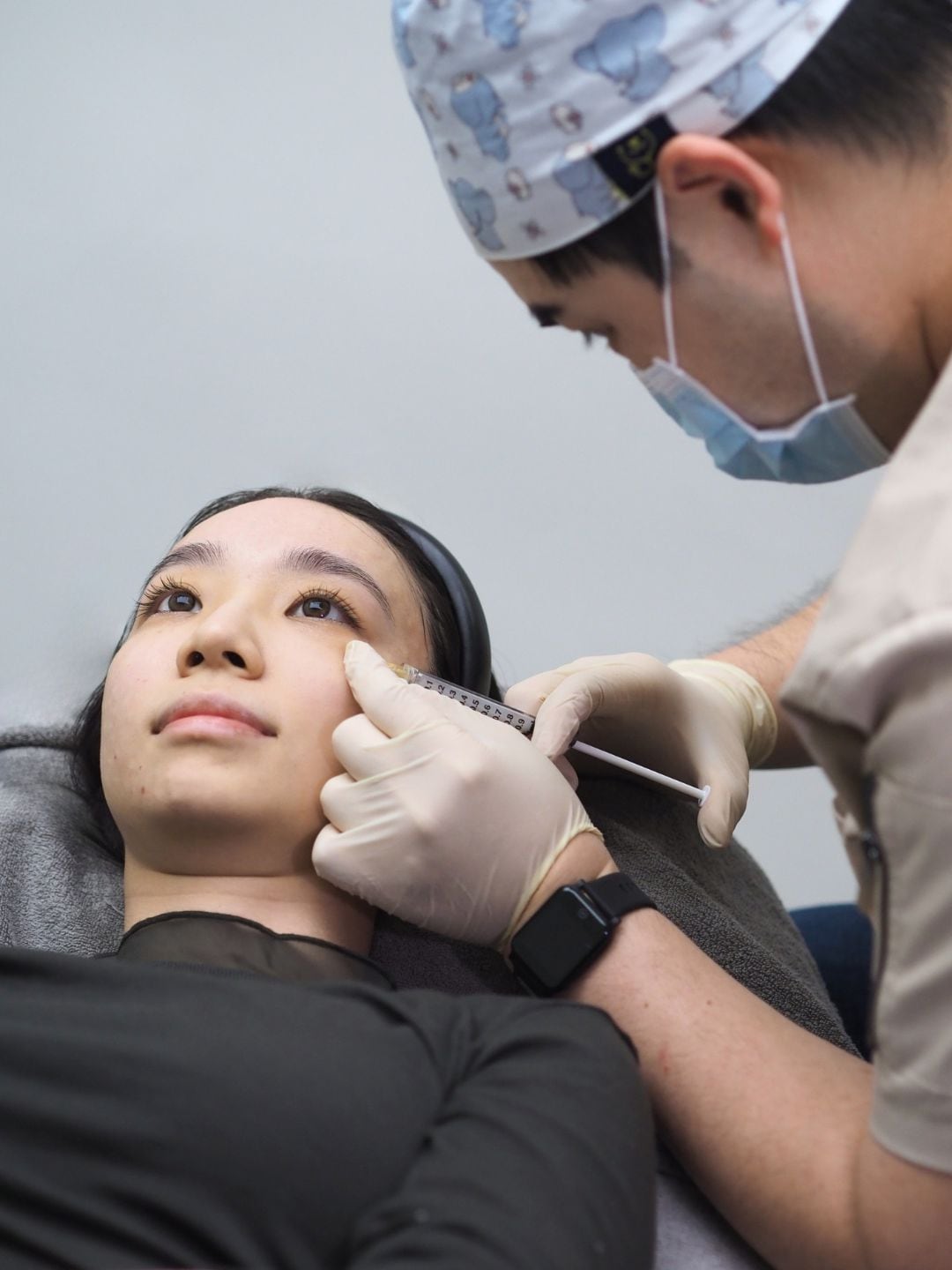Doctor administering a skin booster injection to a patient's cheek at Reborn Skin Clinic